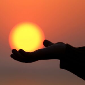 Hand holding sun image